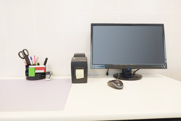 Doctor office table with office tools, monitor, mouse