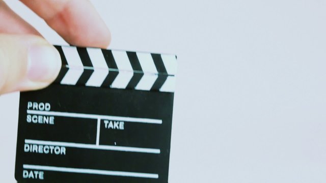 Fingers raise up film clapper and close it isolated