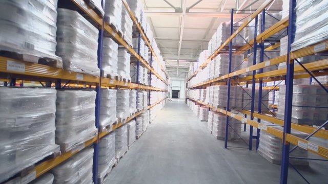 Lot of goods lay on shelves in warehouse of Caparol factory