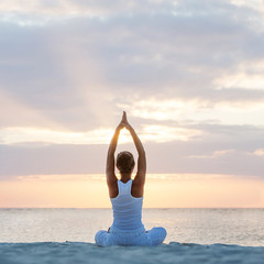 Caucasian woman practicing yoga at seashore - 80166926