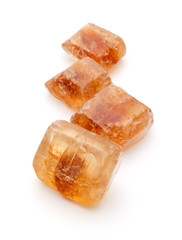 Brown caramelized lump cane sugar cube isolated on white backgro