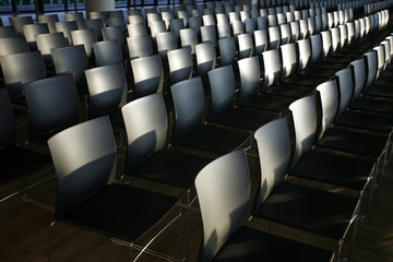 Fototapeta premium Rows of empty chairs prepared for an indoor event