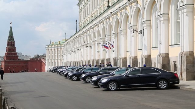 Governmental cars parked near Grand Kremlin Palace and red wall