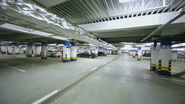 Motion along underground parking with cars 