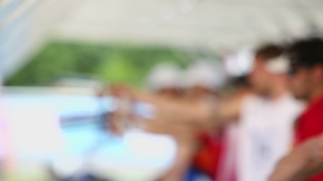 Hand raises electronic gun with battery during shooting contest