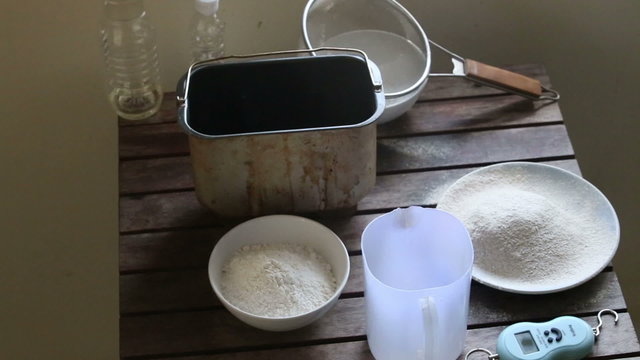 caucasian woman hands sift flour through bolter	