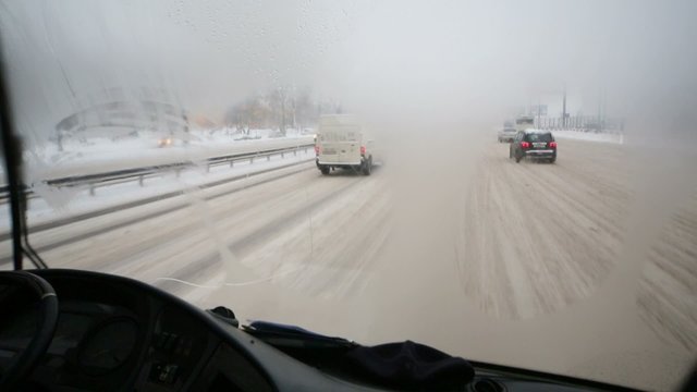 View from cabin of bus through the misted glass with wipers