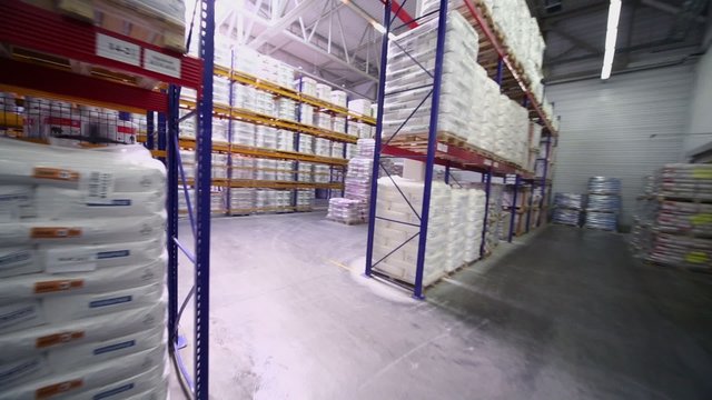 Many products lay on shelves in warehouse of Caparol factory