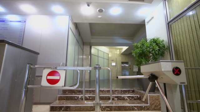 Entrance equipped with turnstile at hall in office building