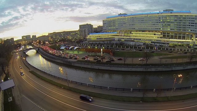 Cars ride by quay near edifice of MGTU named by Bauman at autumn