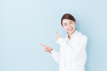 young asian doctor on blue background