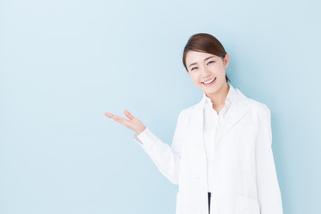 young asian doctor on blue background