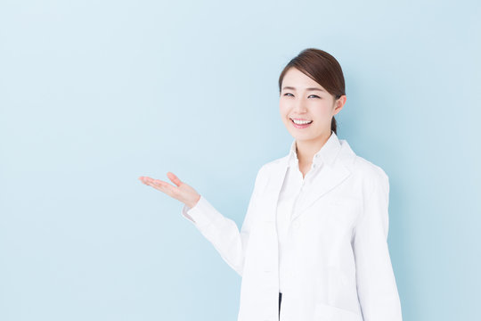 young asian doctor on blue background