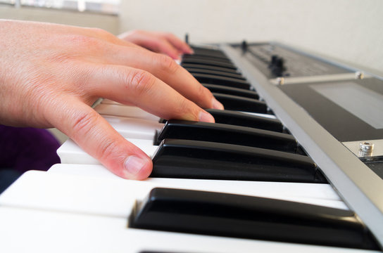 closeup photo of a person's hands playing piano