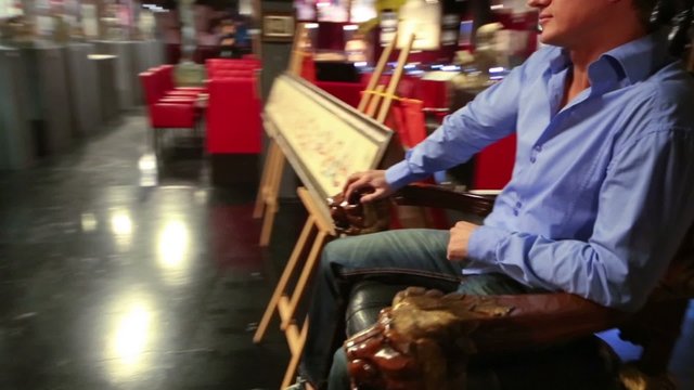 Man sits on a wooden throne in Museum-Shop Point G 