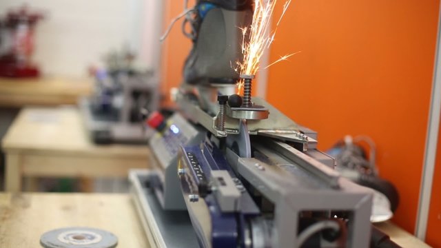 Sharpening of skate blade using automatic grinder.