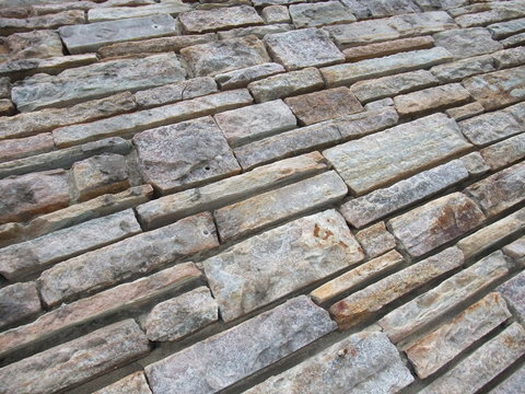 Uneven cracked real stone wall surface