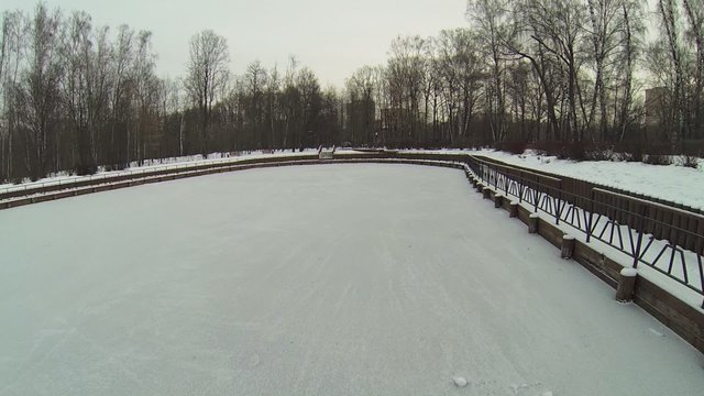 Surface of icy pond in park covered by snow at winder day