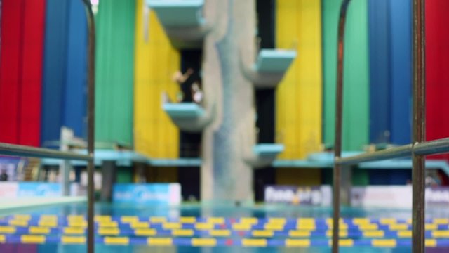 Sportsmen jump from diving-tower during training