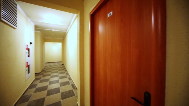 Overview of empty corridors at entrance to residential building.