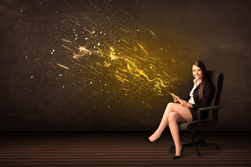 Businesswoman with tablet and energy explosion on background