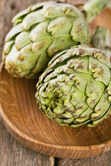Fototapeta premium artichokes on wooden surface