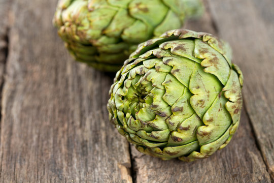 artichokes on old wooden surface