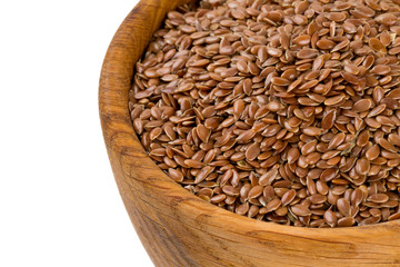 flax seed in a wooden bowl isolated on white