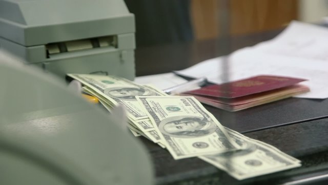 Machine checks money in money exchange office at bank