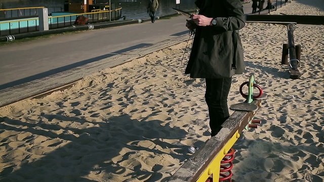 Student using tablet on playground and going somewhere
