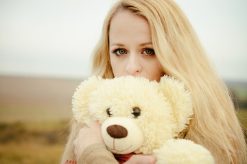 young sensual girl blonde in windy fall with toy