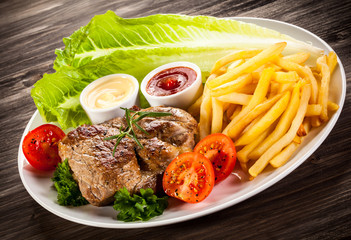 Grilled steak, French fries and vegetables