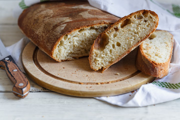 Sliced loaf of homemade bread on cutting board