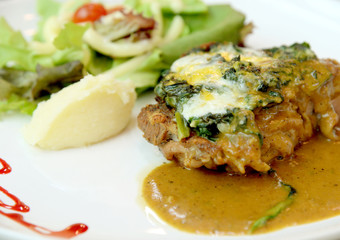Grilled steaks, baked potatoes and vegetables