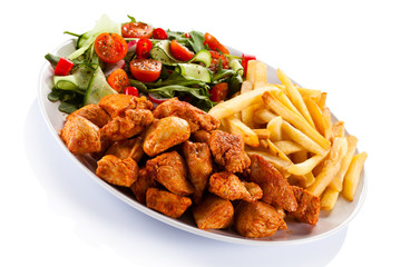 Fried chicken nuggets, French fries and vegetables