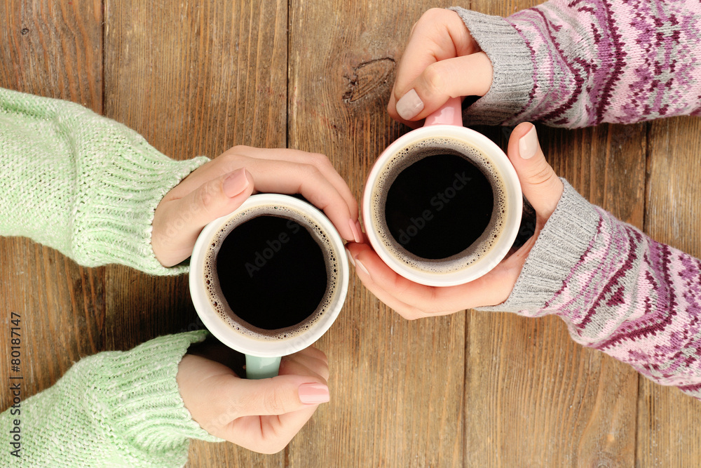 Sticker Female hands holding cups of coffee