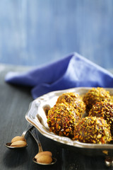 Tasty homemade pistachio candies on wooden table