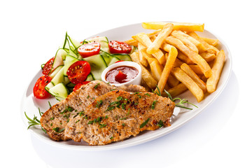 Pork chops, French fries and vegetables