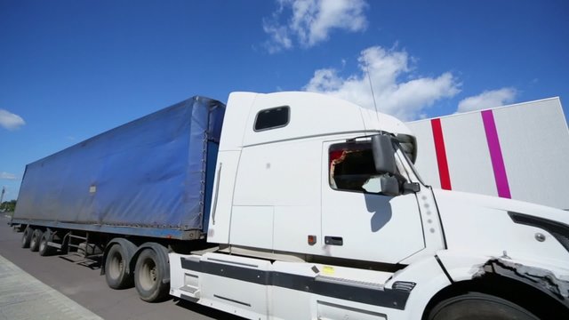 Trucks stand near warehouse of Caparol factory 