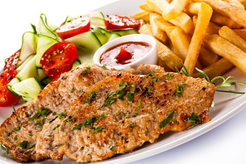 Pork chops, French fries and vegetables