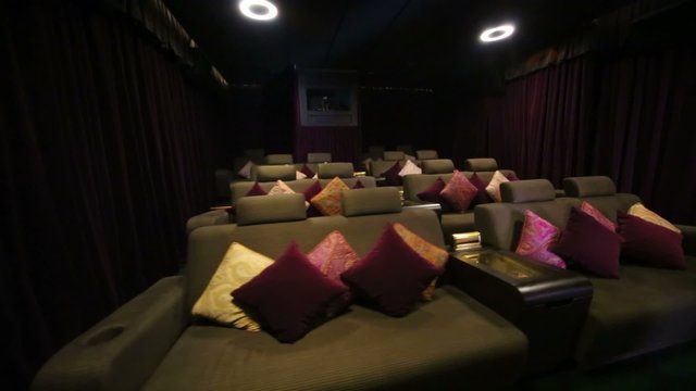 Review cozy hall with soft sofas with projector in cinema at GUM