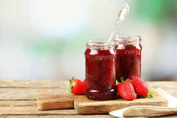 Jars of strawberry jam with berries