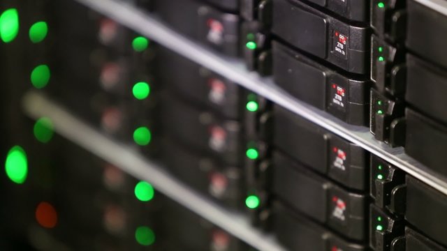 Rack of data server with many hard drives and LED lamps blinks