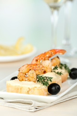 Appetizer canape with shrimp and olives