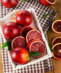 Fresh blood oranges in  white wooden box. Top view