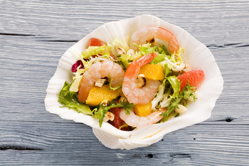 Shrimp salad with grapefruit, orange and roasted peanuts. - Serv