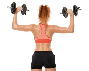 Young fit woman working out with dumbbells