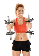 Fototapeta na wymiar Young fit woman working out with dumbbells