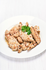 Grilled chicken meat sliced on white plate