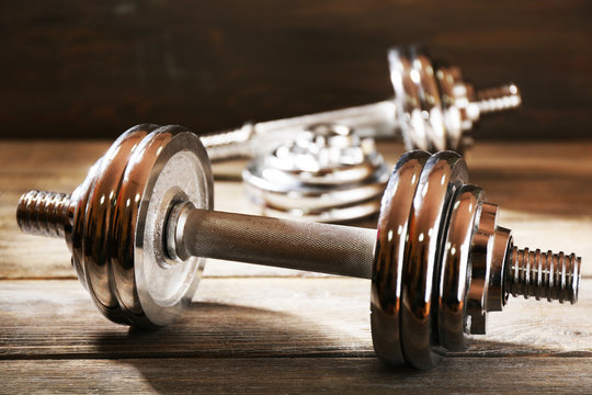 Big Dumbbells On Wooden Background